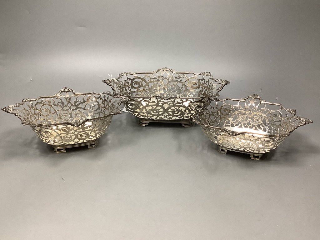 An Edwardian graduated set of three pierced silver shaped rectangular bonbon dishes by William Comyns